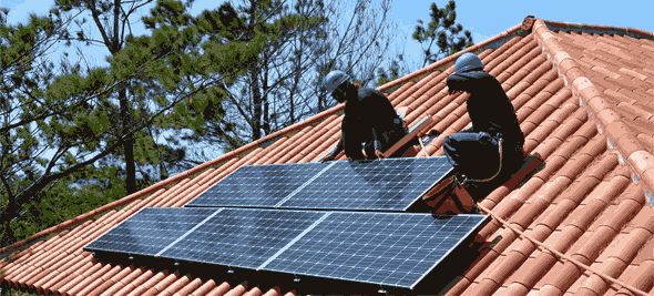 Workers cleaning and maintaining solar panels